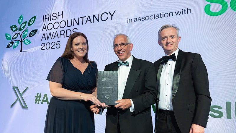 Paula Egan, head of sales UKI, Sage, presents the practice of the year award to Frank Walsh and Joe O'Brien, Walsh O'Brien Harnett