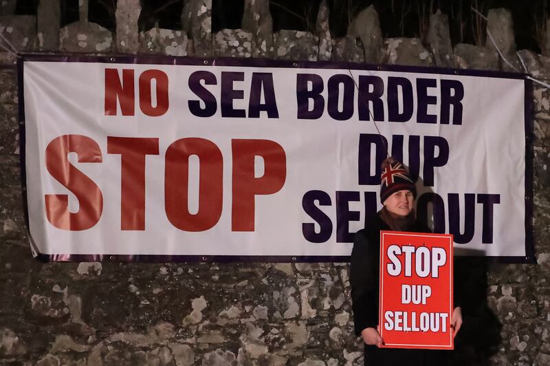 A protester outside Larchfield Estate on Monday night where the DUP held a private party meeting. Photograph: Liam McBurney/PA Wire