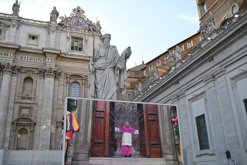  A large screen shows the master of papal liturgical ceremonies, Archbishop Diego Ravelli closing the doors of the Sistine Chapel as conclave begins to elect the next pope Photo: Antonio Masiello/Getty Images