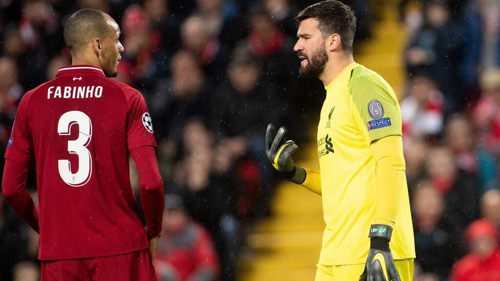 Liverpool’s Fabio Henrique speaks with goalkeeper Alisson Becker during the Champions League round of 16 match against Bayern Munich at Anfield in February 2019. Photograph: Getty Images