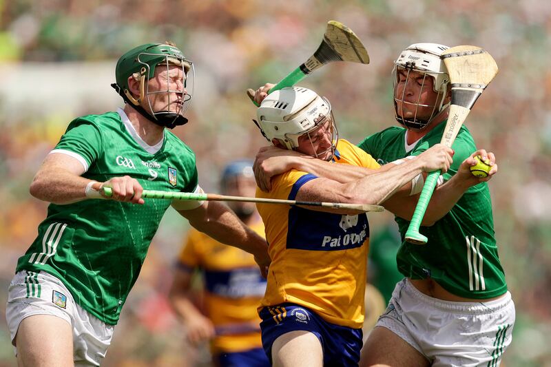 Clare's Ryan Taylor with William O'Donoghue and Kyle Hayes of Limerick. Photograph: Laszlo Geczo/Inpho
