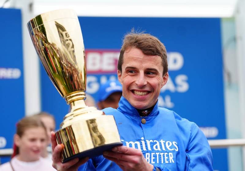 William Buick lifts the trophy after winning the Betfred 2000 Guineas Stakes at Newmarket. Photograph: David Davies/PA