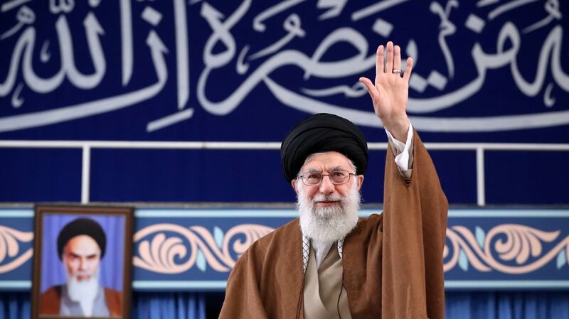 Iranian supreme leader Ayatollah Ali Khamenei greeting the crowd during a meeting with Iranian students in Tehran, Iran, today. Behind him is a portrait of his predecessor,  Ayatollah Ruhollah Khomeini, founder of Iran as an Islamic Republic. Khamenei has held the position of supreme leader for almost 30 years. Photograph: Handout/EPA