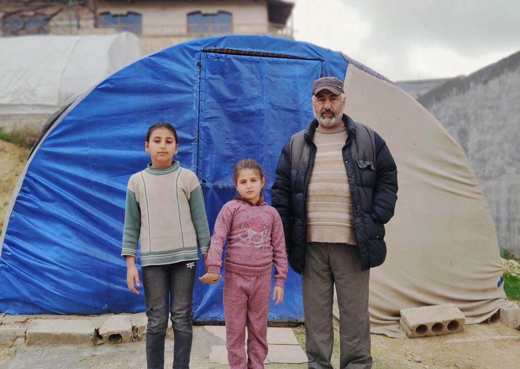Rafiq with his daughters Leila (10) and Yasmine (7) outside the tent they’ve lived in since the earthquakes
