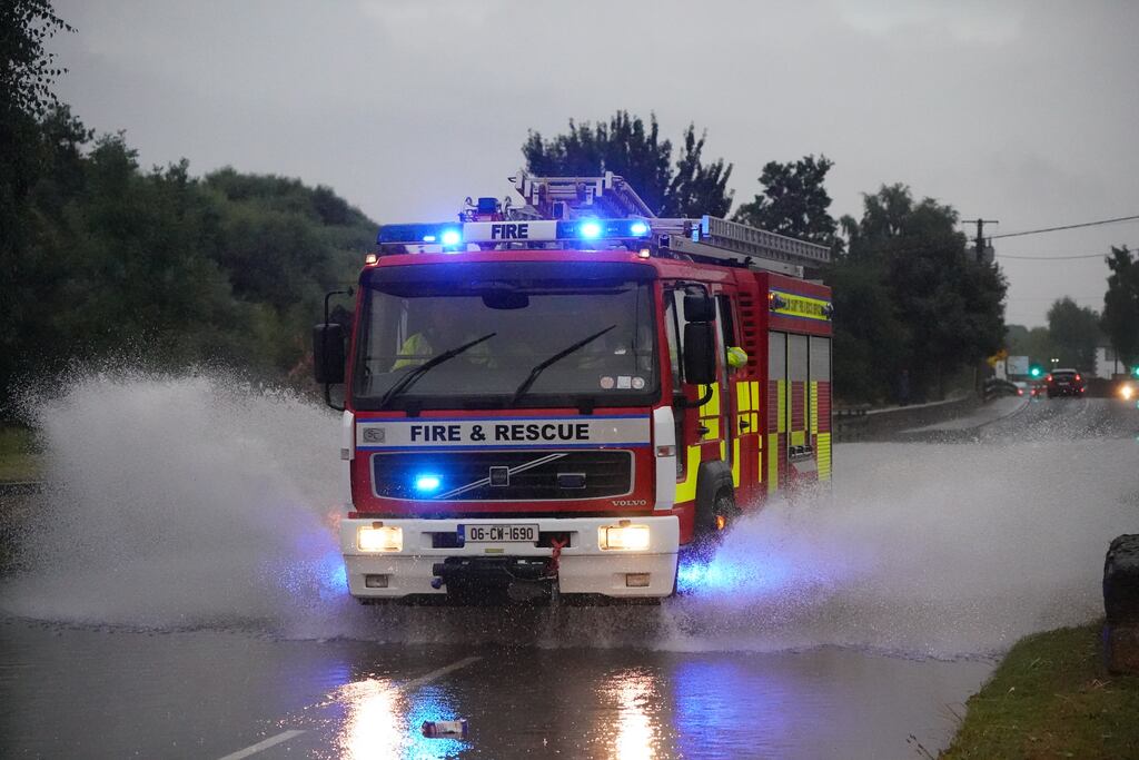 Units of the fire brigade assisted communities affected by flooding in Wexford and, as pictured above, parts of Carlow. Photograph: Niall Carson/PA