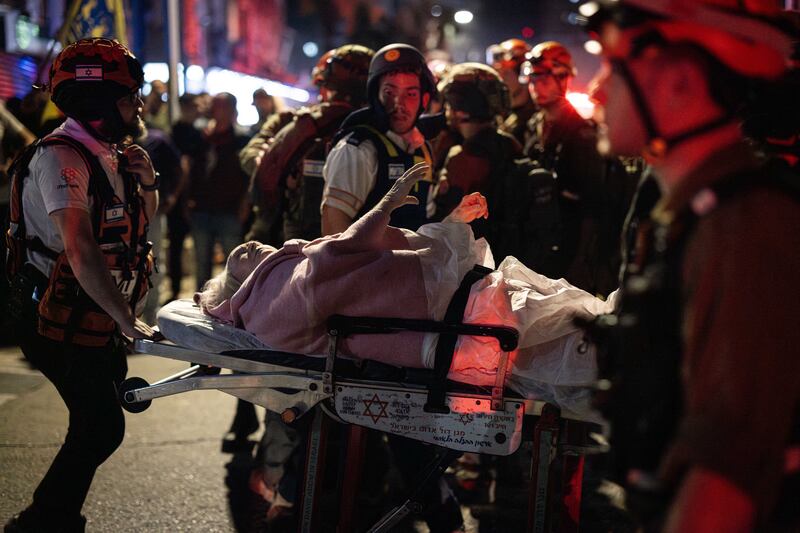 Israeli medics carry a person wounded in Iran's missile attack in Bat Yam, a suburb of Tel Aviv, on June 15th, 2025. Photograph: FAIZ ABU RMELEH/Middle East Images/AFP via Getty Images