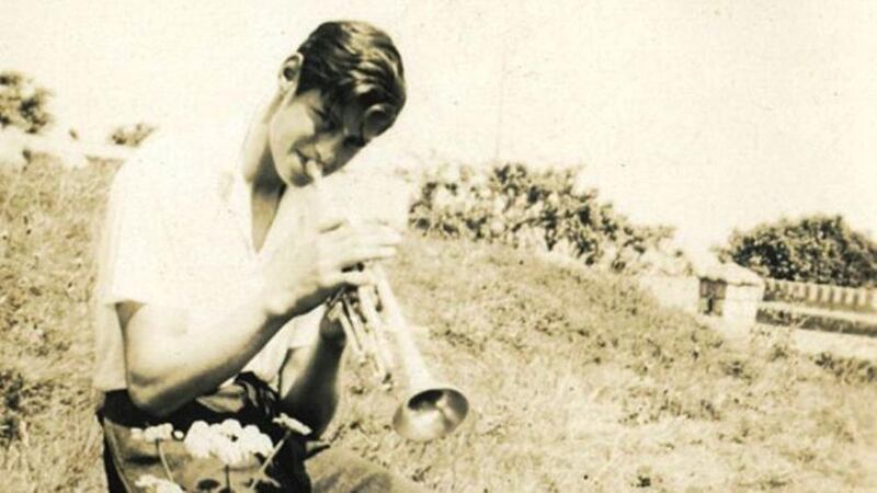 Ivor Browne playing the trumpet in the field beside the family home in Sandycove