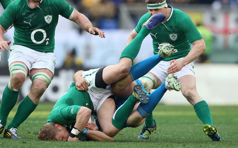 Ireland's Ian Madigan is tackled. Photograph: Billy Stickland/Inpho
