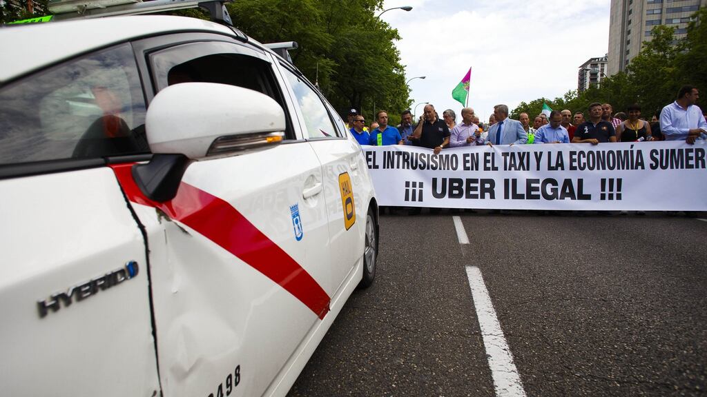 Demonstrators carry a banner in a protest against the Uber app in central Madridin 2014. Photograph: Angel Navarrete/Bloomberg