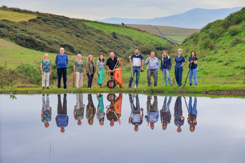 Ireland’s Greenest Places 2025: Máire Uí Mhurchú, Val Behan, Fionna Sheehy, Catríona Fallon, Ann Ní Chiobhán, Dinny Galvin, Tommy Reidy, Martin Bealin, Martha Farrell, Grainne Kelliher and Deirdre de Bhailís at the newly created pond for biodiversity at Dinny Galvin's farm. Photograph: Valerie O'Sullivan