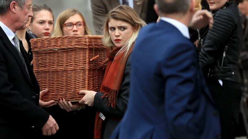 Eileen Battersby’s daughter helps bear her mother’s remains on the final journey. Photograph: Donall Farmer