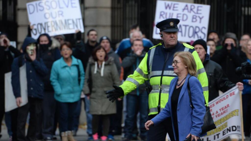 Water protesters shout at Jan O’Sullivan TD Minister for Education & Skills as she crosses the street outside Leinster House, Dublin on Wednesday. Photograph; Dara Mac Dónaill / The Irish Times
