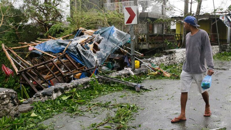 A man looks at a damaged house due to strong winds from Typhoon Mangkhut in  Tuguegarao city in Cagayan province, northeastern Philippines on Saturday. Photograph: Aaron Favila/AP.