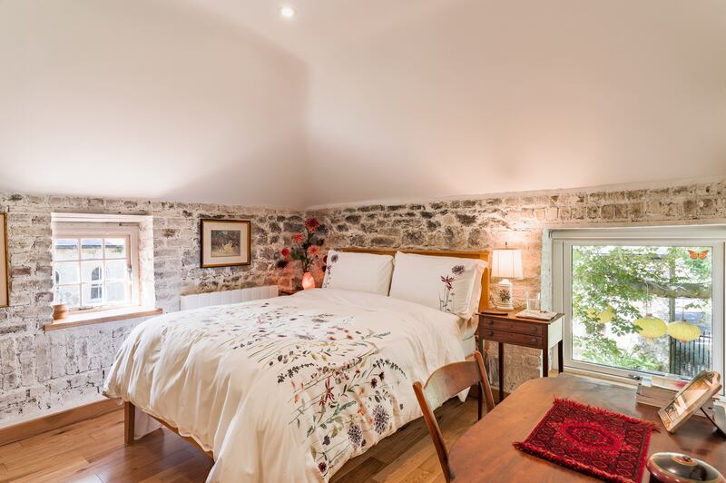The two bedrooms in the hayloft take a more modern approach than the downstairs