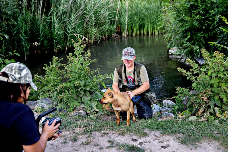 Maggie Carter films her husband, Joseph Carter, and his dog Bindi during a hunt at Fitts Park in Salt Lake City, Utah. Photograph: Kim Raff/The New York Times