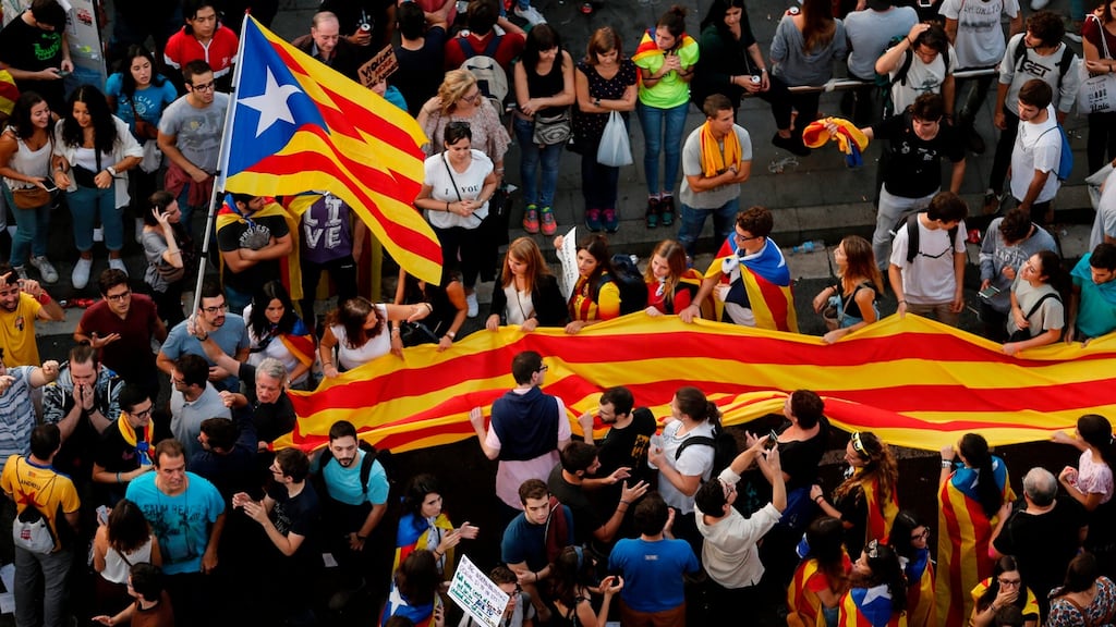 Protesters hold a giant Catalan pro-independence ‘Estelada’ flag during a demonstration at the Placa de la Universitat square in Barcelona during a general strike in Catalonia called by Catalan unions on October 3rd. Photograph: Pau Barrena/AFP/Getty Images