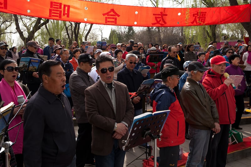 People gather to song together in a choir at Yuyuantan Park in Beijing. Photograph: Andrea Verdelli/Anadolu Agency/Getty Images