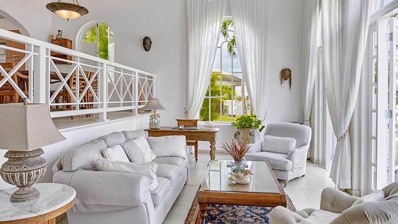 The two-bedroom villa in Barbados  has a split-level dining room and terrazzo patios.