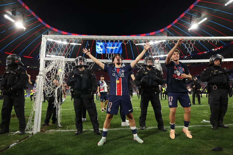 Paris Saint-Germain's Vitinha and Joao Neves celebrate in front of supporters on Saturday night in Munich. Photograph: Franck Fife/Getty