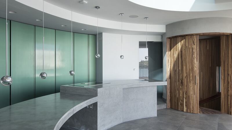 The kitchen at the Dalkey waterfront house was painted in pearlescent green to reflect the internal light.