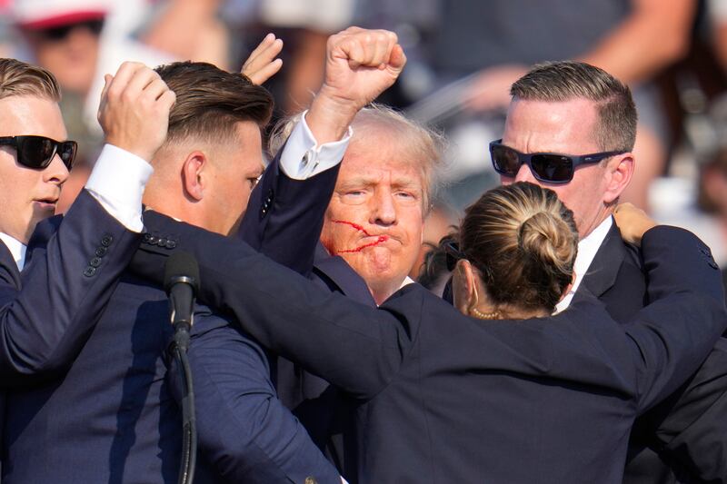 Donald Trump is helped off the stage after the shooting. Photograph: Gene J Puskar/AP