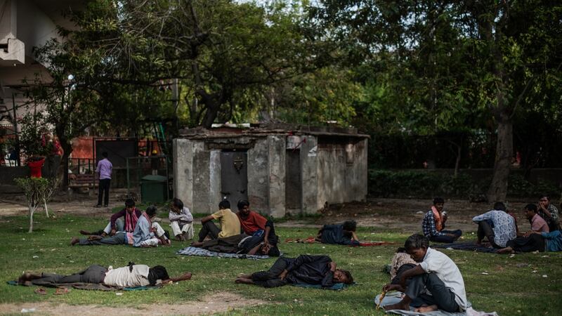 Migrant workers rest at a park in New Delhi. Photograph: Rebecca Conway/The New York Times