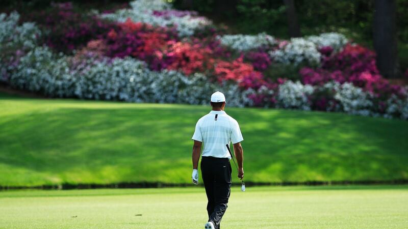 Woods walks to the drop zone at the 12th after finding the water for the second day running. Photo: Tannen Maury/EPA