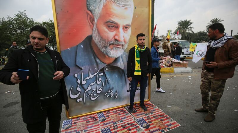 Supporters of the Hashed al-Shaabi paramilitary force and Iraq’s Hezbollah brigades pose next to a poster of  Qassem Suleimani.  Photograph: Ahmad Al-Rubaye/AFP via Getty Images