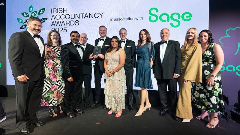 Geetika and Rohith Garg, managing partners, Axon Outsourcing Limited, presents the medium practice of the year award to Merry Mullen team