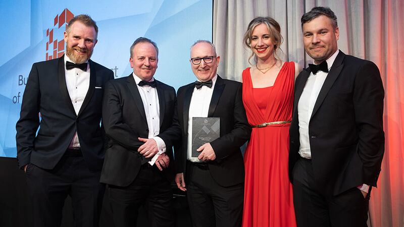 Cathal McGuinness, director, SAS International, presents the building of the year – office (large) award to the Henry J Lyons team