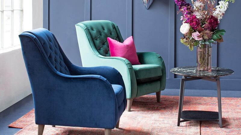 The Irish-made Studio is a sturdy wood-frame upholstered seat featuring detailed stitching and rounded arm rests.