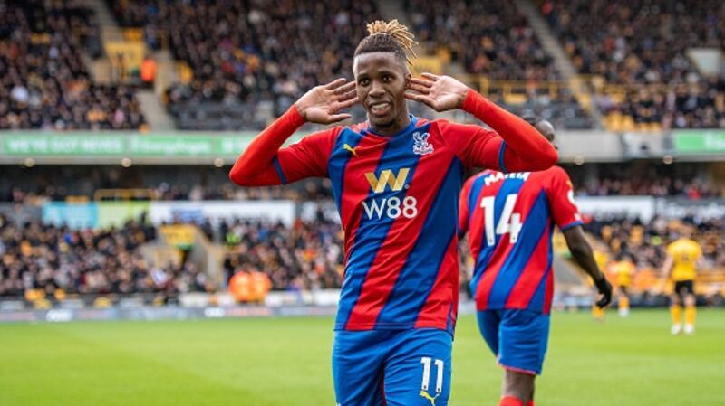 Wilfried Zaha celebrates after scoring his penalty. Photograph:  Sebastian Frej/MB Media/Getty Images