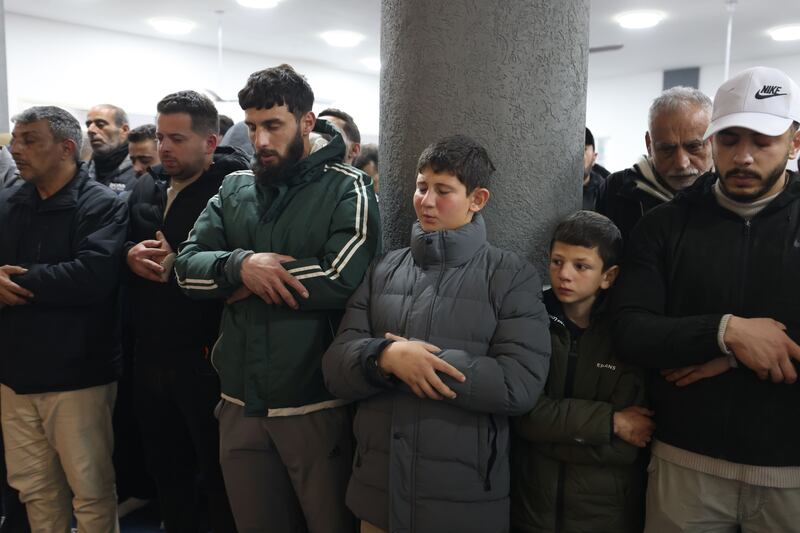 Relatives pray during the funeral of four members of the Palestinian Bani Odeh family in Tamoun village, near the West Bank city of Tubas, on Sunday. Photograph Alaa Badarneh/EPA