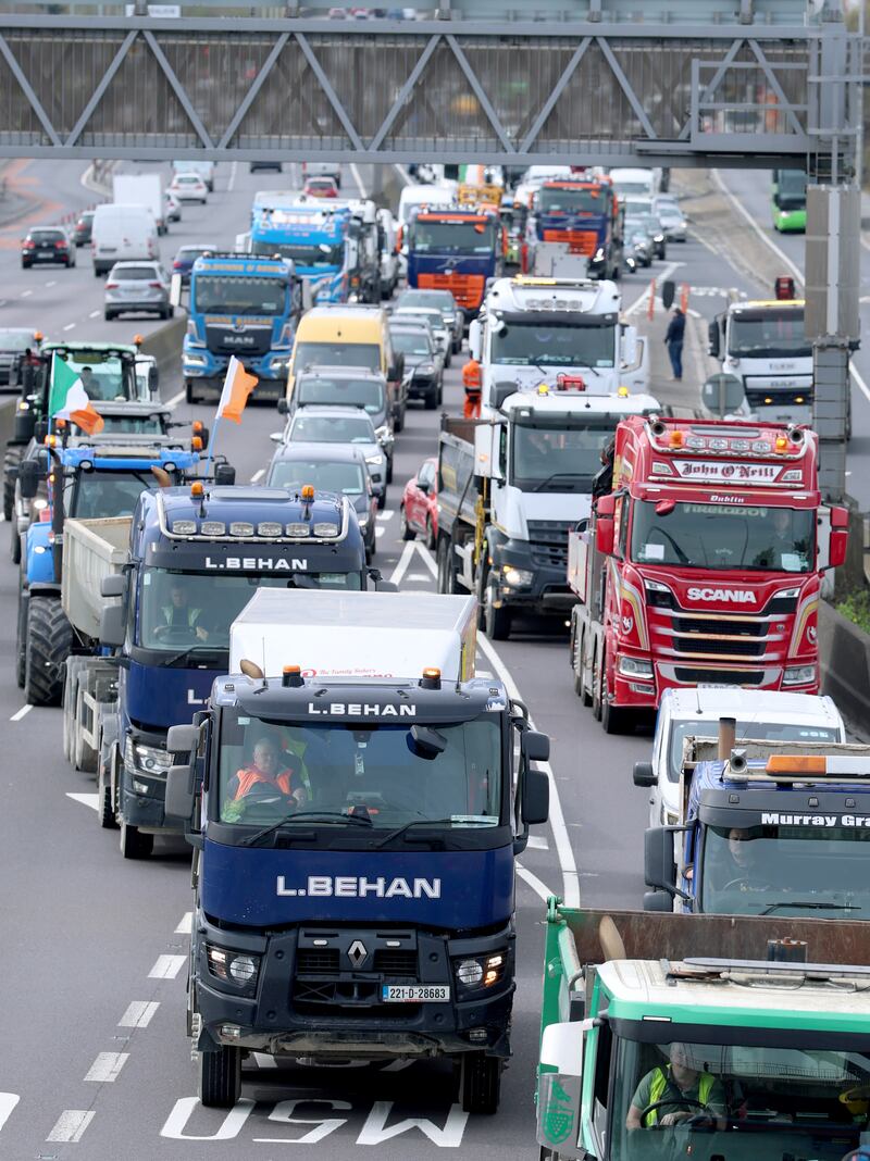 Vehicles taking part in a National Fuel Protest pass under the Joe Williams Bridge on the N7 motorway near Clondalkin, Dublin. Gardaí have warned that the slow moving convoys may cause "significant" traffic disruption, with large vehicles, including HGVs, agricultural and plant vehicles, gathering at various locations across the country. Photograph: Liam McBurney/PA Wire