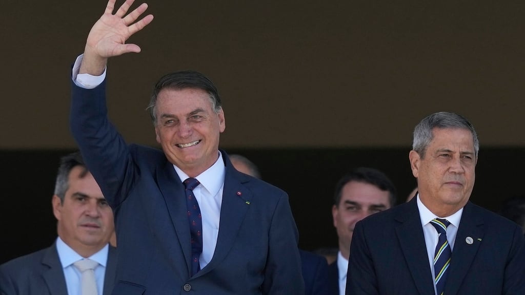Brazilian president Jair Bolsonaro with defense minister Walter Braga Netto as a military convoy passes Planalto presidencial palace in Brasilia on Tuesday. Photograph: Eraldo Peres/AP Photo