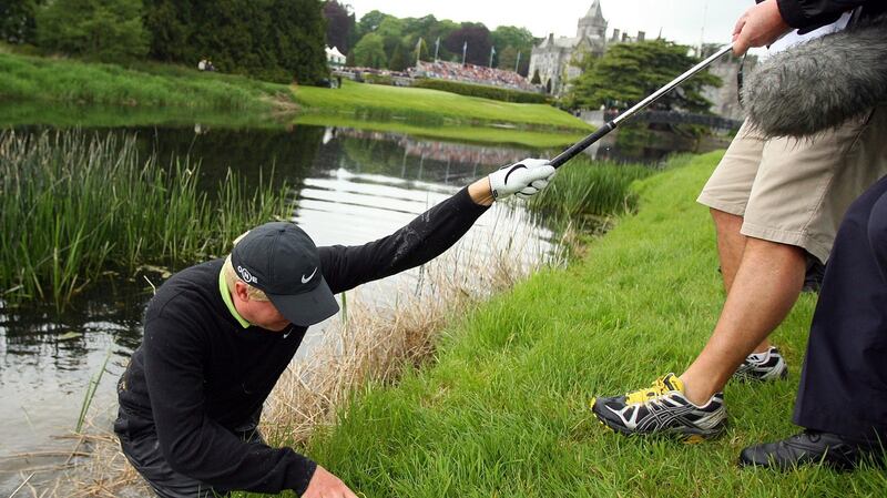 Richard Finch is helped out of the River Maigue at Adare Manor after falling in playing his third shot to the 18th hole on the way to winning the 2008 Irish Open. Photograph: Cathal Noonan/Inpho