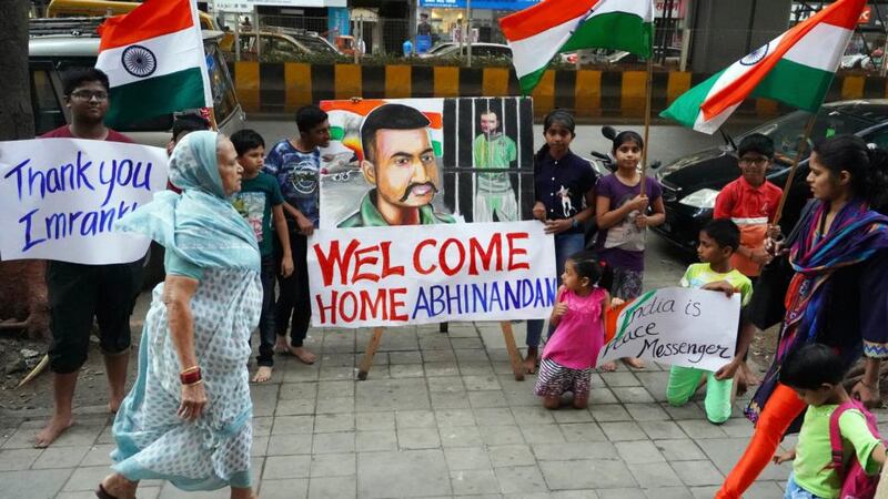 Children stand with a painting of Indian Air Force Wing Commander Abhinandan Varthaman, a day before his release from Pakistan, on February 28th in Mumbai, India. Photograph:  Hemanshi Kamani/Hindustan Times/Getty