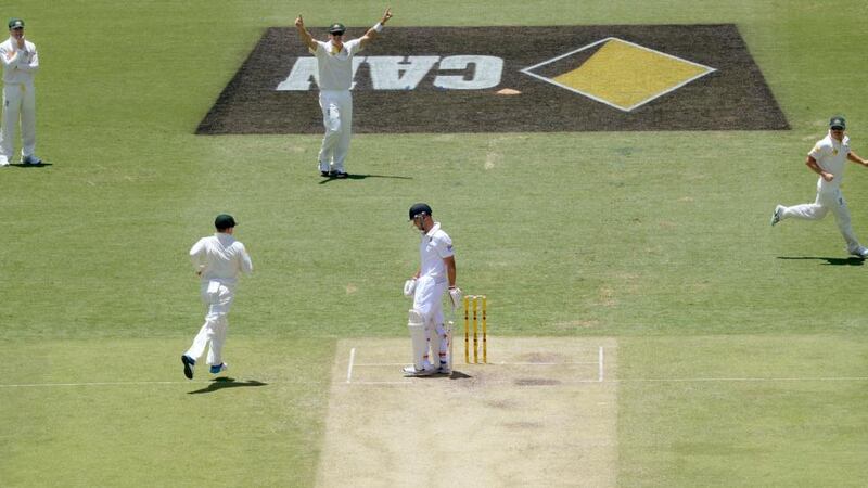 England’s Jonathan Trott (centre) after losing his wicket to the bowling of Australia’s Mitchell Johnson (not pictured) at The Gabba. Photograph: Anthony Devlin/PA Wire