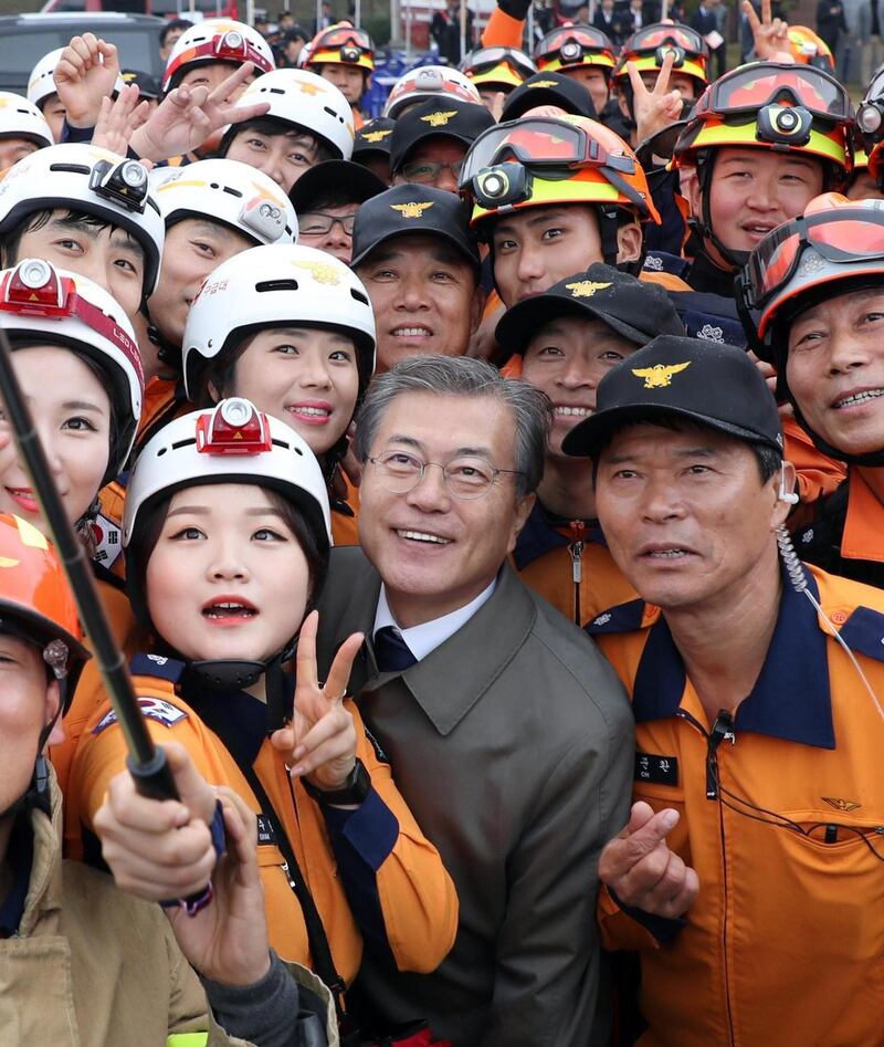 South Korean president Moon Jae-in  poses for a selfie with firefighters at an event to celebrate Firefighters Day  in Cheonan, South Korea, on Friday. Photograph: Yonhap/EPA