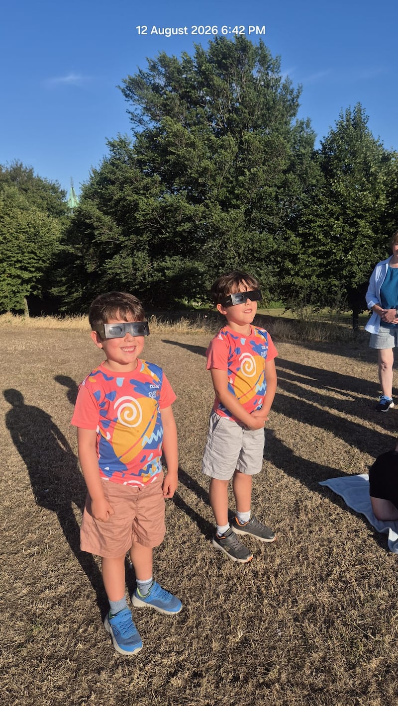 Theo and Ollie Columbus Murphy watching the eclipse in Eamon Ceannt Park in Crumlin, Dublin. Photo by Claire Murphy