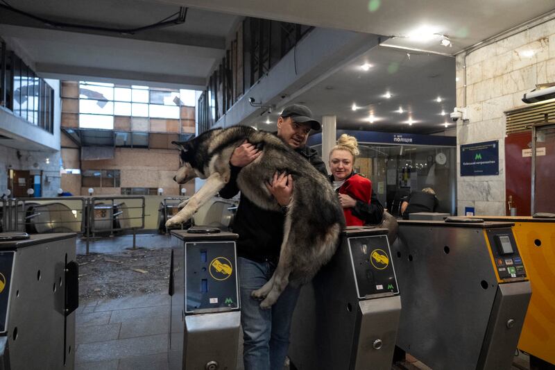 A man carries a dog in a damaged metro station following a Russian attack in Kyiv last week. Photograph: Oleksi Filippov/AFP