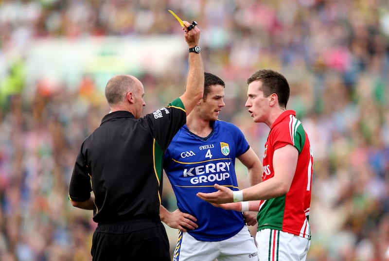 Cormac Reilly yellow cards Kerry’s Shane Enright and Cillian O'Connor of Mayo. Photograph: James Crombie