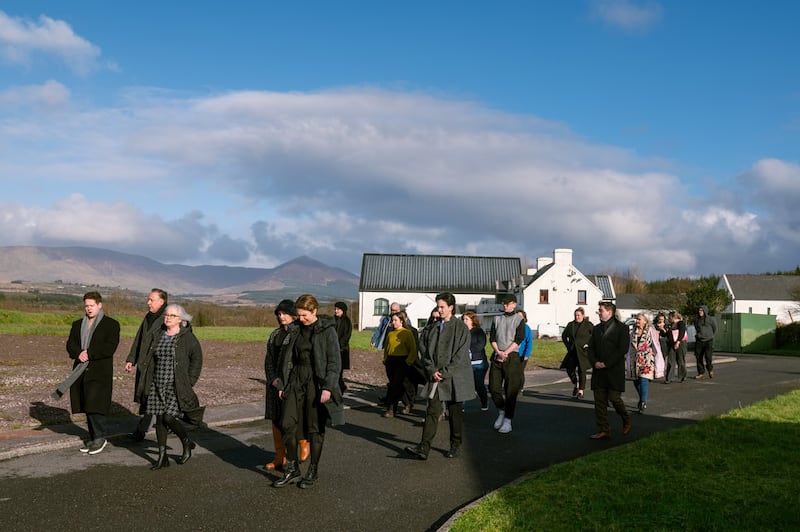 Taigh Ty Teach cast members lead the audience to the next performance venue. Photograph: Nathan Snow