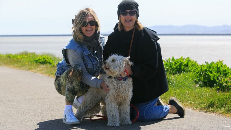 Sarah Shannon (left) and Margo Shannon  from Clonskeagh with Millie, a cockapoo,  enjoying the good weather at Dollymount Beach, Dublin. Photograph:  Collins