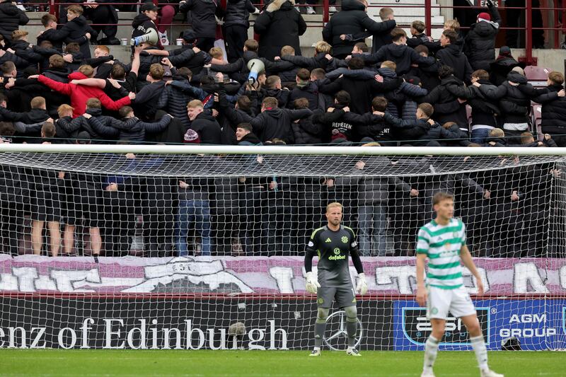 Hearts fans huddle in celebration during their team's win over Celtic last Sunday. Photograph: Steve Welsh/PA Wire