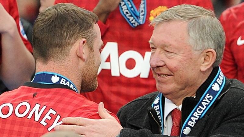 Former Manchester United manager  Alex Ferguson with Wayne Rooney before the trophy presentation last season. Photograph: Martin Rickett/PA Wire
