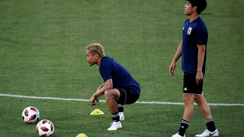 Japan’s Yuto Nagatomo (left) stretches before a  training  ahead of the  World Cup Round of 16 match against Belgium at Rostov Arena. Photograph:  Carl Court/Getty Images