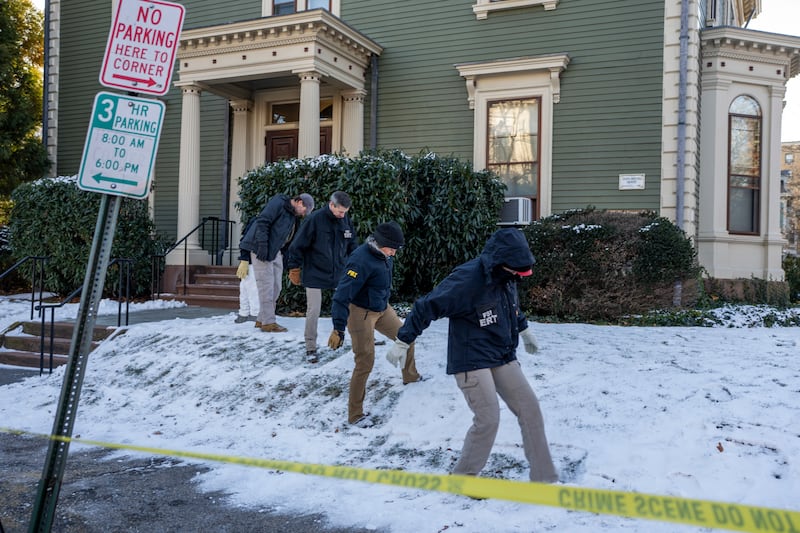 Members of the FBI’s evidence response team look through a yard near where footage showed the supposed attacker. Photograph: Christopher Capozziello/The New York Times