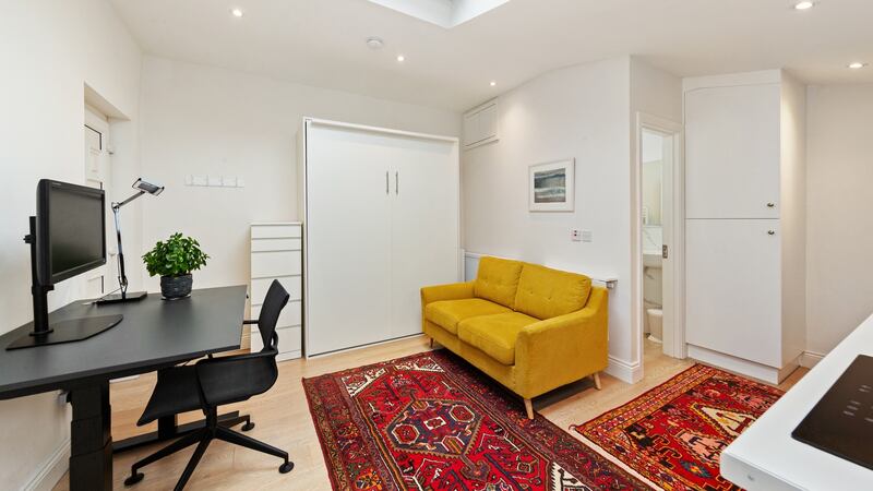 Separate home office with bathroom and wall-mounted fold-up bed