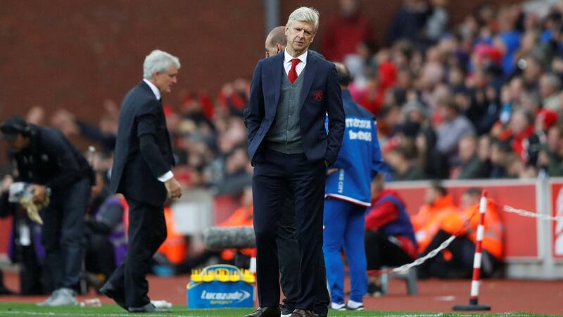 Arsenal manager Arsene Wenger and Stoke City manager Mark Hughes.  Photograph: Carl Recine/Reuters